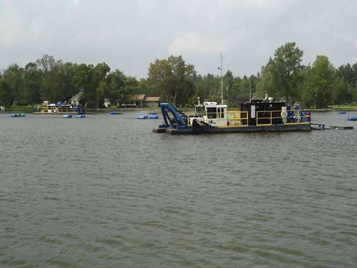 A Michigan contractor uses a 7012 HP Versi-Dredge and a 5012 HP Versi-Dredge to clean out an inland lake.