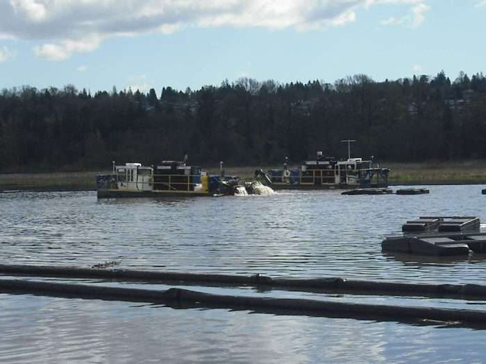 Two IMS 5012 LP Versi-Dredge cleaning out a lake in Canada.